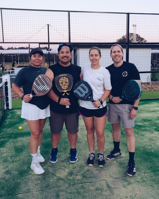 Four players with racquets on court